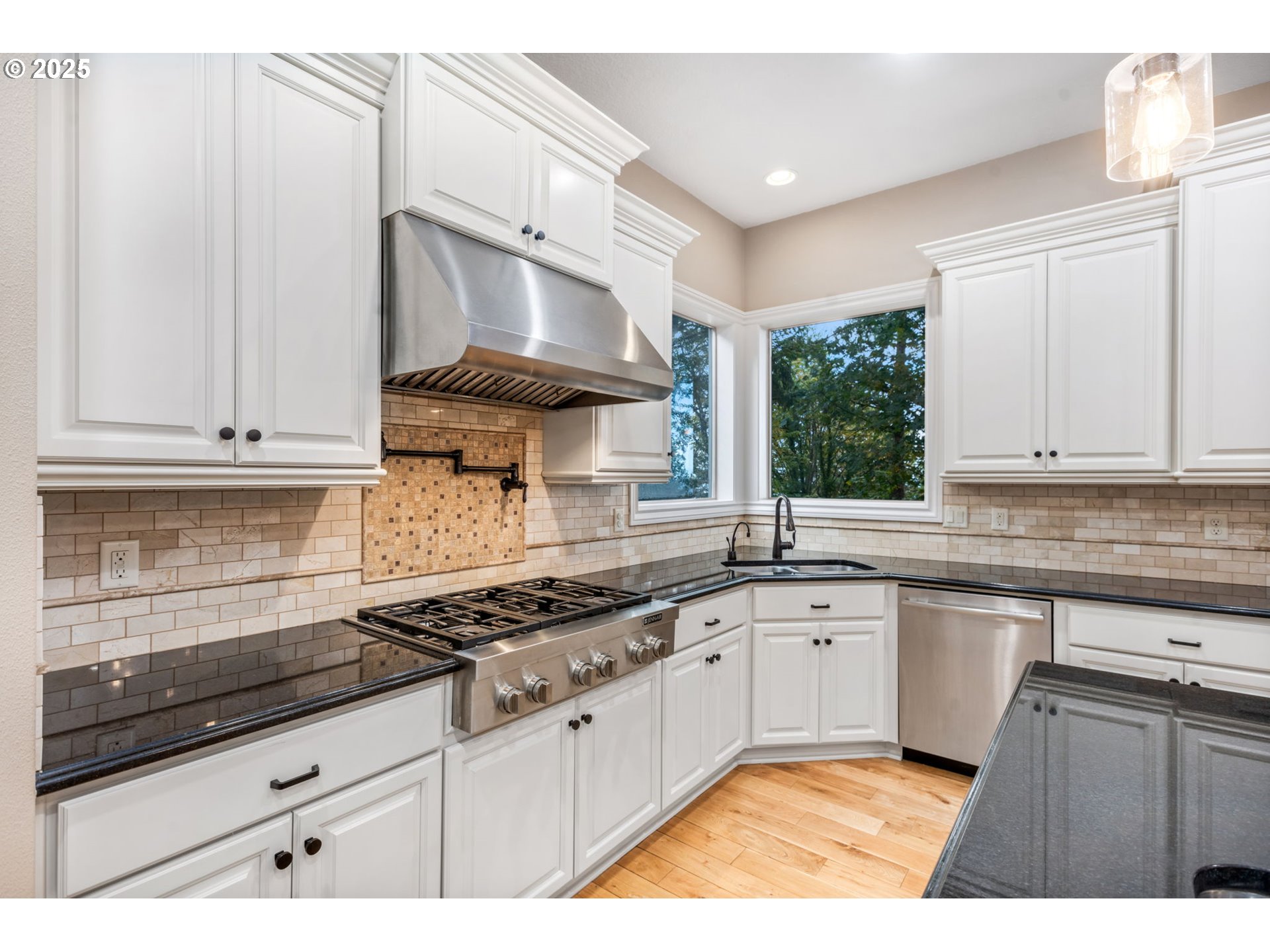 4530 Southwest Council Crest Drive Portland, OR 97239 - Photo 9 of 43 a kitchen with granite countertop a sink stainless steel appliances and cabinets