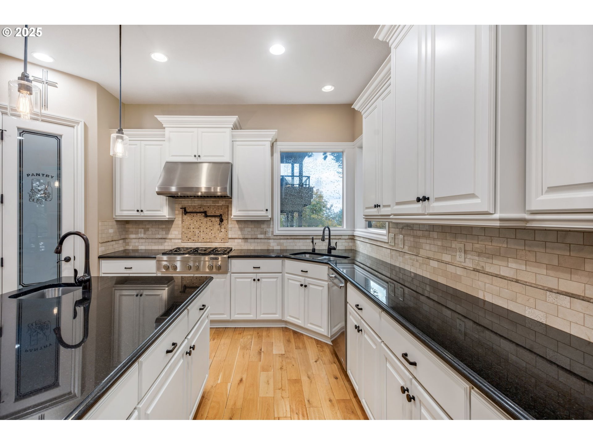 4530 Southwest Council Crest Drive Portland, OR 97239 - Photo 10 of 43 a kitchen with granite countertop a sink stainless steel appliances and cabinets