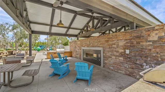 a view of a patio with couches chairs dining table and chairs under an umbrella