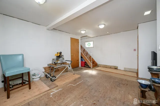 a livingroom with furniture and a potted plant