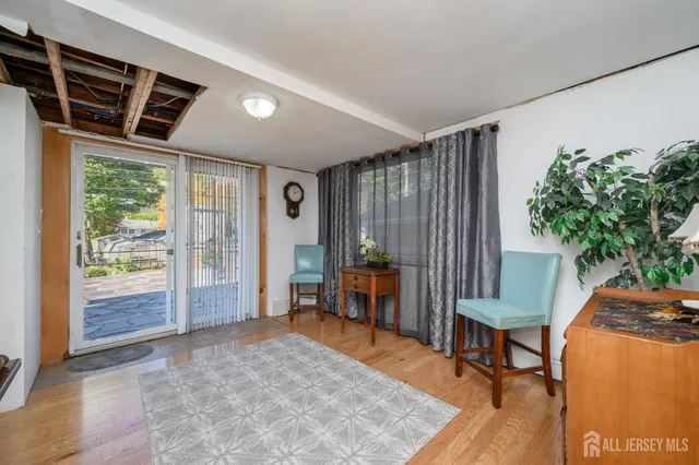a view of a room with furniture and wooden floor