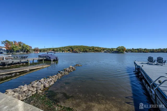 an aerial view of a house with a swimming pool and outdoor seating
