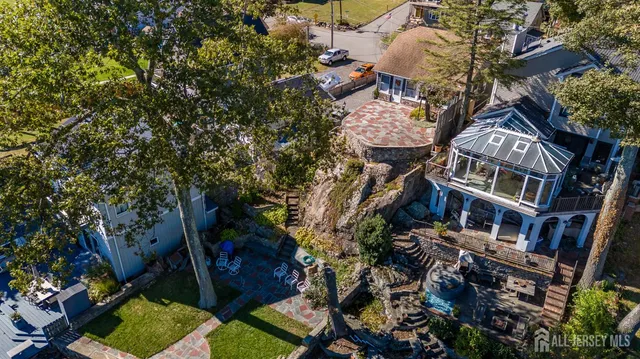 an aerial view of residential houses with outdoor space and trees