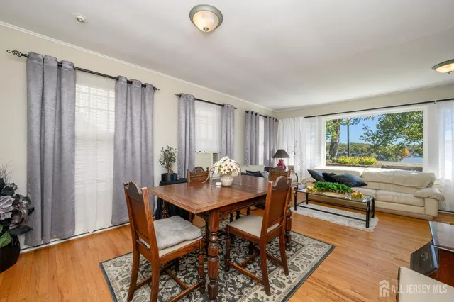 a kitchen with stainless steel appliances a refrigerator a sink dishwasher and a dining table