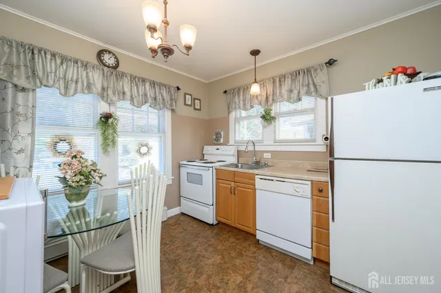 a living room with furniture and a refrigerator
