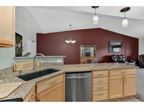 a kitchen with kitchen island granite countertop a stove cabinets and microwave