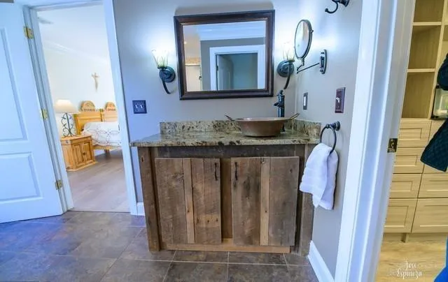 a bathroom with a granite countertop sink a mirror and a vanity