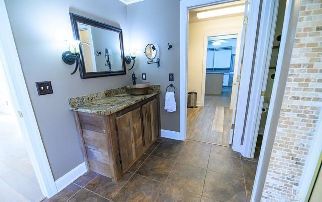 355 Golf View Drive Cohutta, GA 30710 - Photo 21 of 41 a bathroom with a granite countertop sink a mirror and a vanity