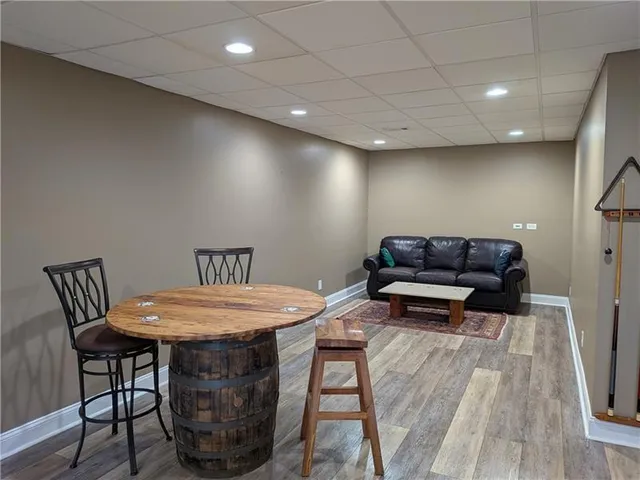 a living room with furniture a wooden floor and a table