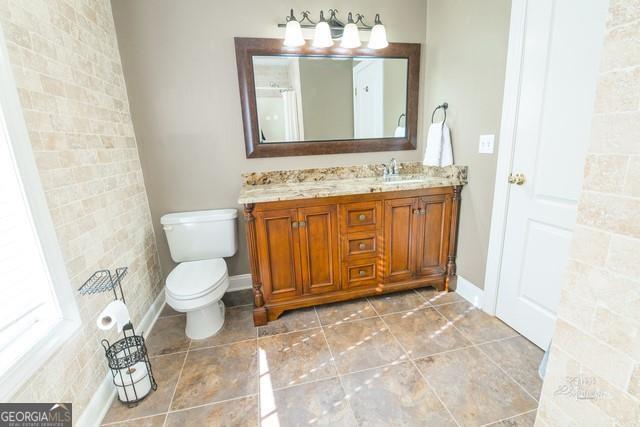 355 Golf View Drive Cohutta, GA 30710 - Photo 31 of 45 a bathroom with a granite countertop toilet sink and mirror
