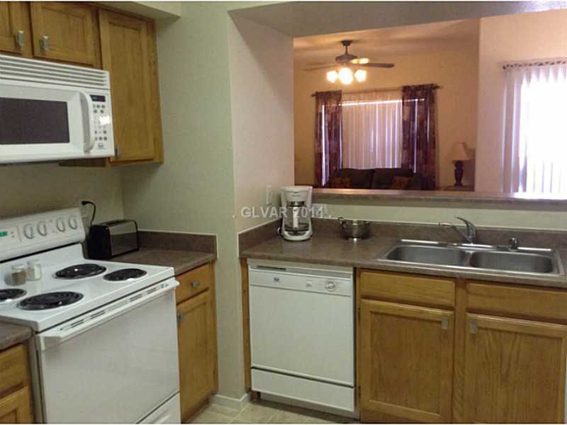 9620 West Russell Road, Unit 1015 Las Vegas, NV 89148 - Photo 2 of 22 Kitchen. SPACIOUS KITCHEN WITH BREAKFAST BAR OVERLOOKS DINING ROOM, LIVING AND PATIO!