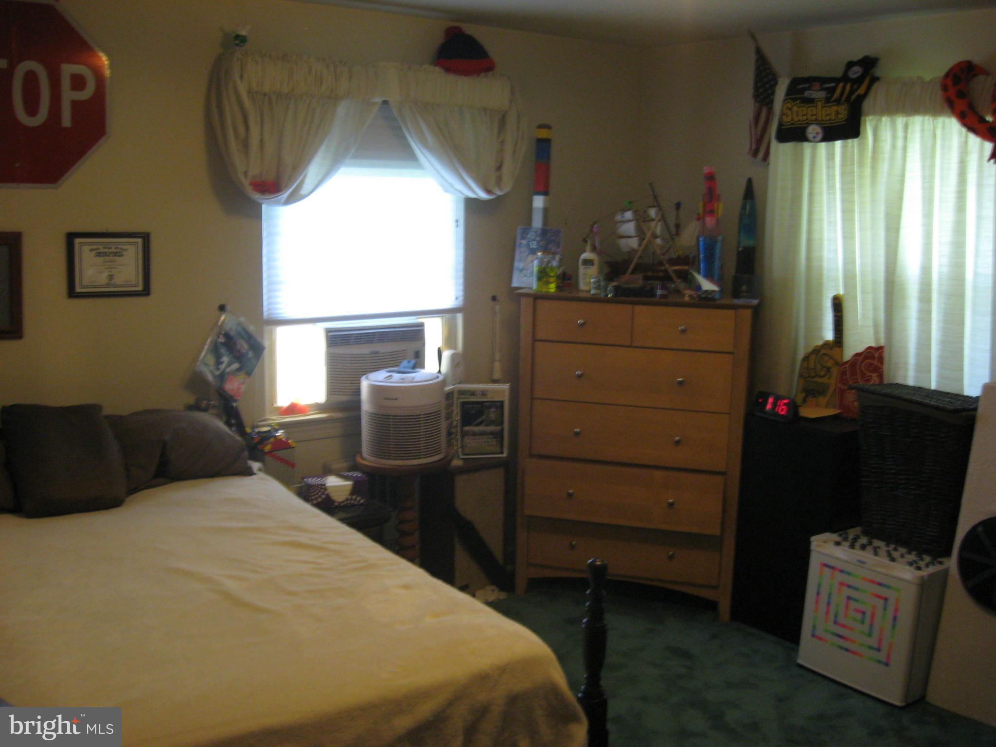 14709 Claude Lane Silver Spring, MD 20905 - Photo 16 of 21 a bedroom with a bed and a mirror
