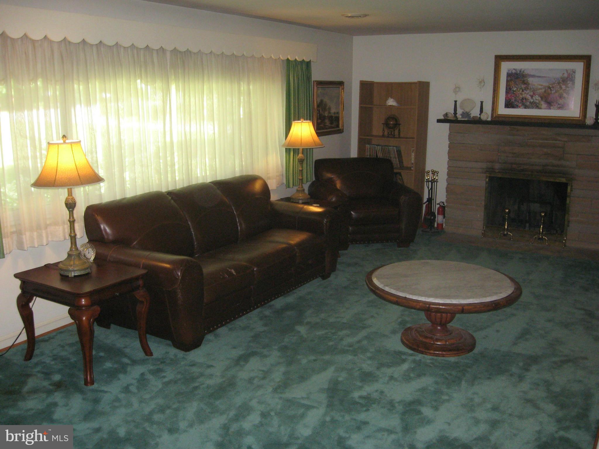 14709 Claude Lane Silver Spring, MD 20905 - Photo 3 of 21 a living room with furniture a lamp and a fireplace