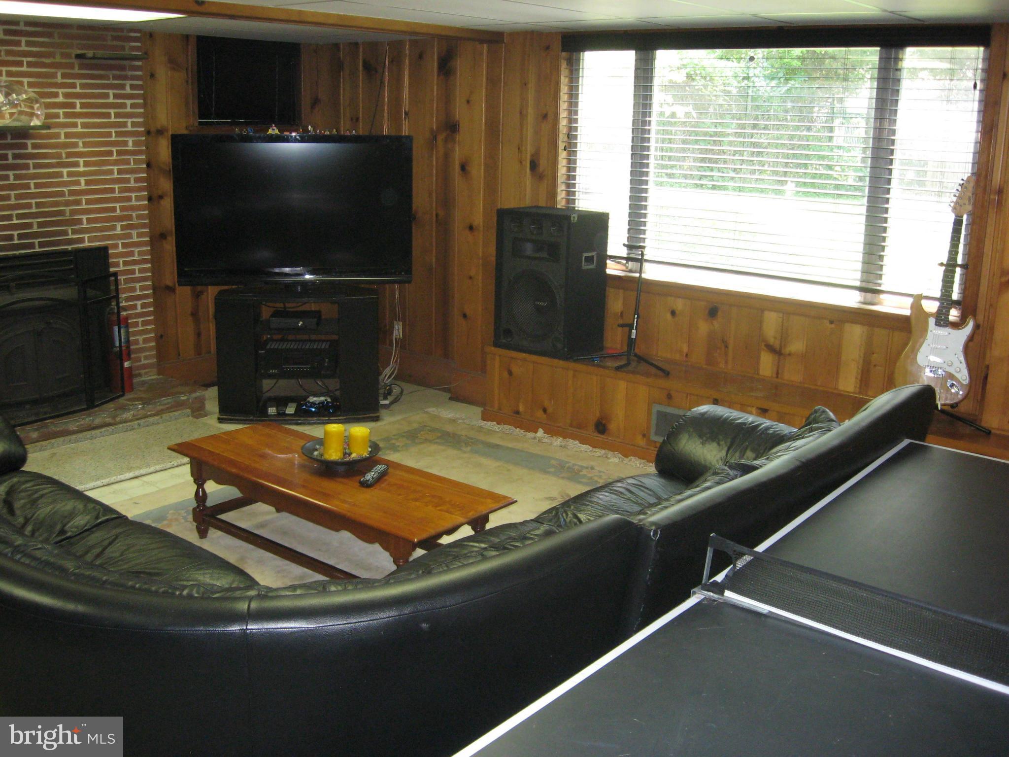 14709 Claude Lane Silver Spring, MD 20905 - Photo 10 of 21 a room with furniture and a flat screen tv