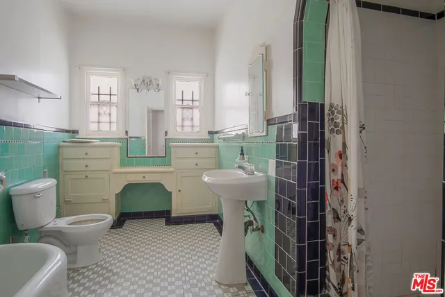 a bathroom with a sink toilet and a shower