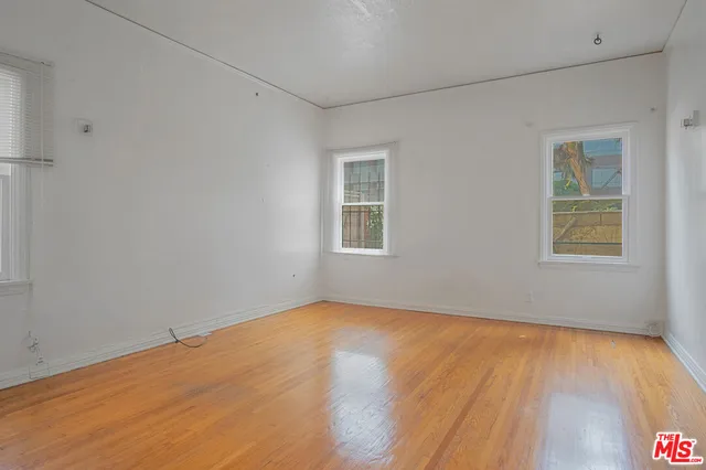a view of a room with wooden floor and windows