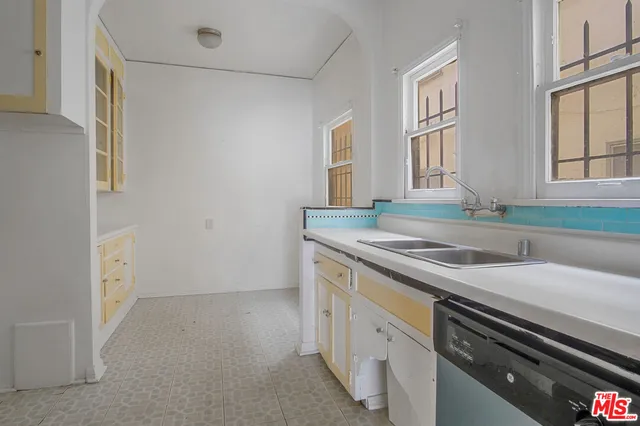 a kitchen that has a sink and a stove