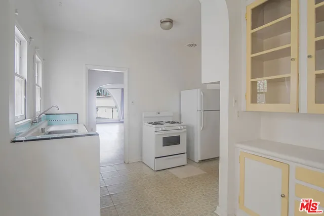 a kitchen with stainless steel appliances granite countertop a stove and a refrigerator