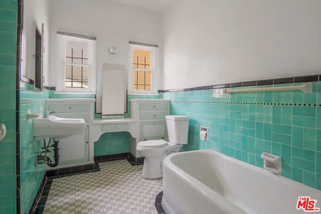 a bathroom with a sink a toilet and bathtub