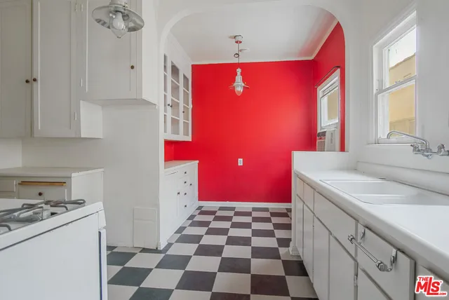 a kitchen with a sink a stove a refrigerator and a stove