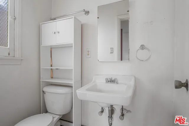 a white toilet sitting next to a bathroom sink