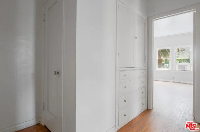 a view of a hallway with wooden floor