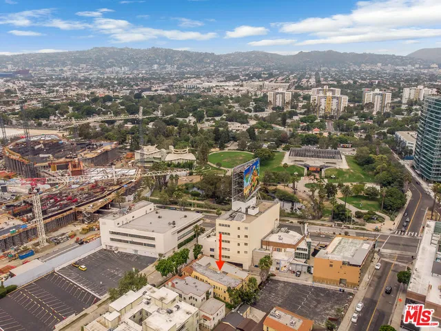 an aerial view of residential houses with city view