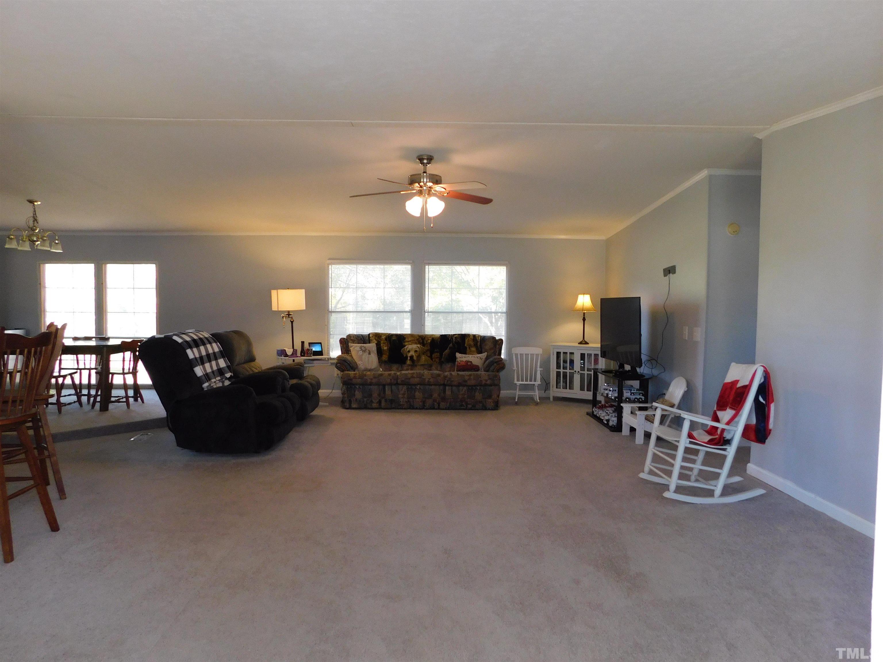 7180 Driver Road Zebulon, NC 27597 - Photo 2 of 19 a living room with furniture and a chandelier