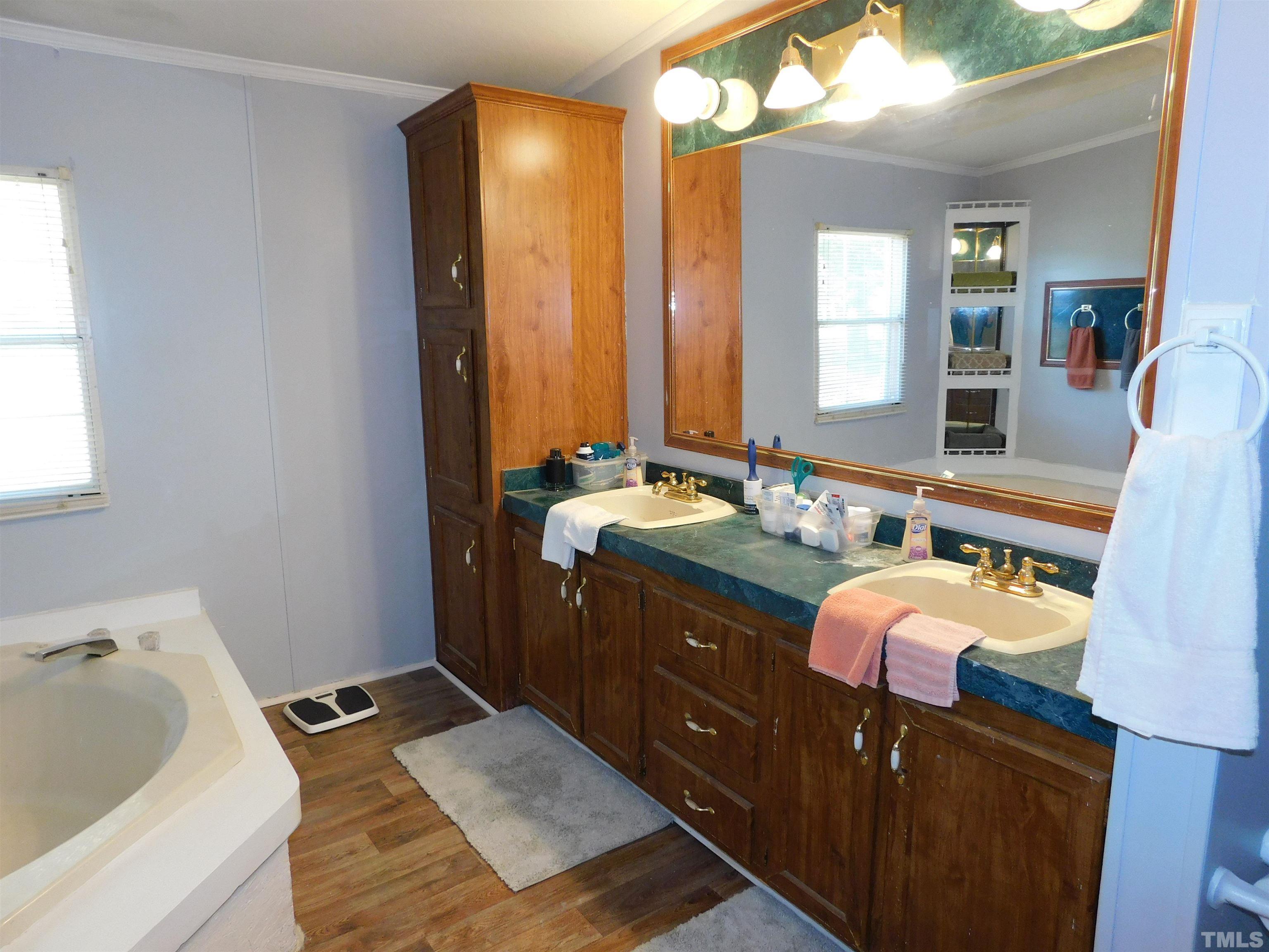 7180 Driver Road Zebulon, NC 27597 - Photo 12 of 19 a spacious bathroom with a double vanity sink and a mirror