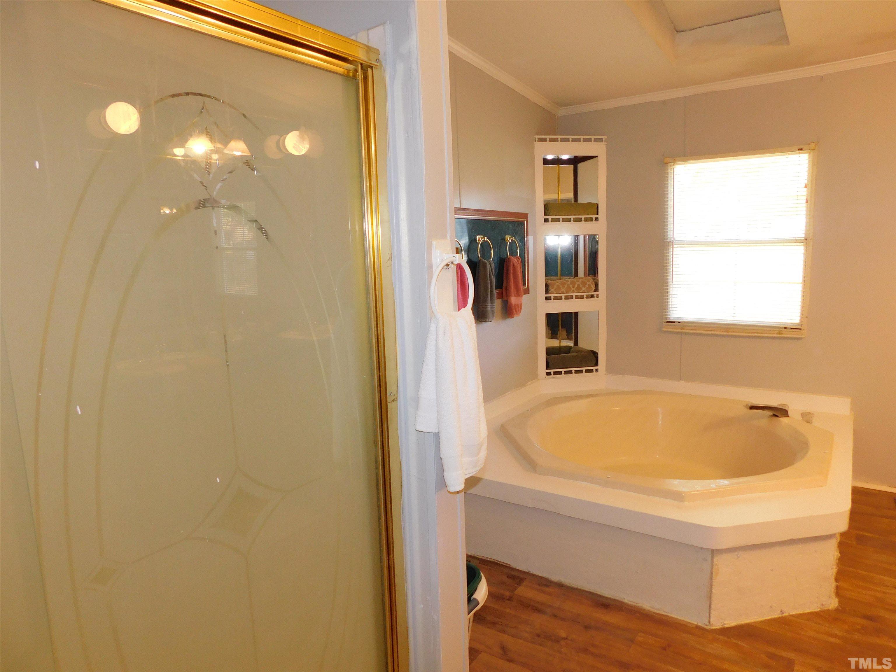 7180 Driver Road Zebulon, NC 27597 - Photo 13 of 19 a bathroom with a tub and a window