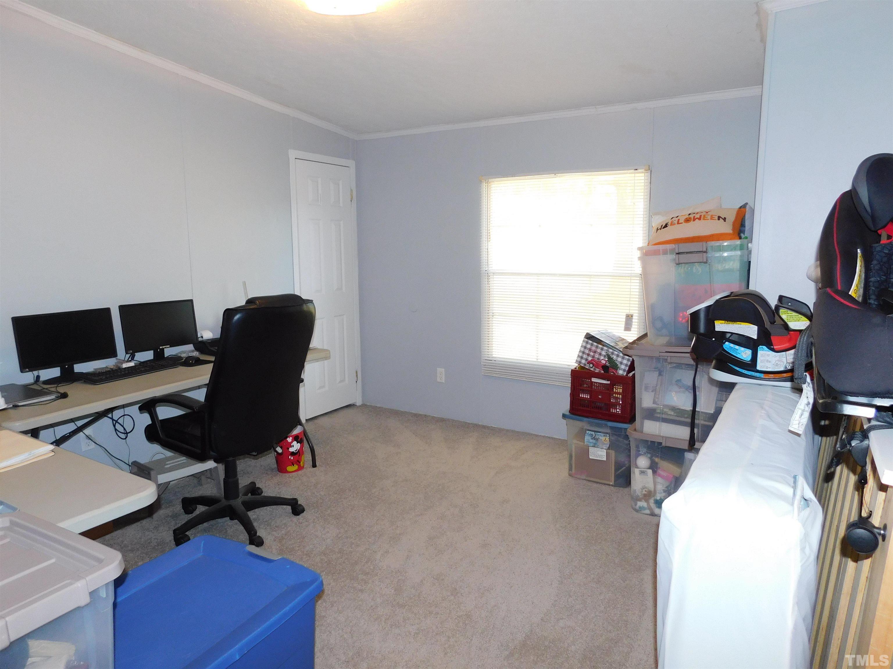 7180 Driver Road Zebulon, NC 27597 - Photo 16 of 19 a view of a workspace with furniture and a window