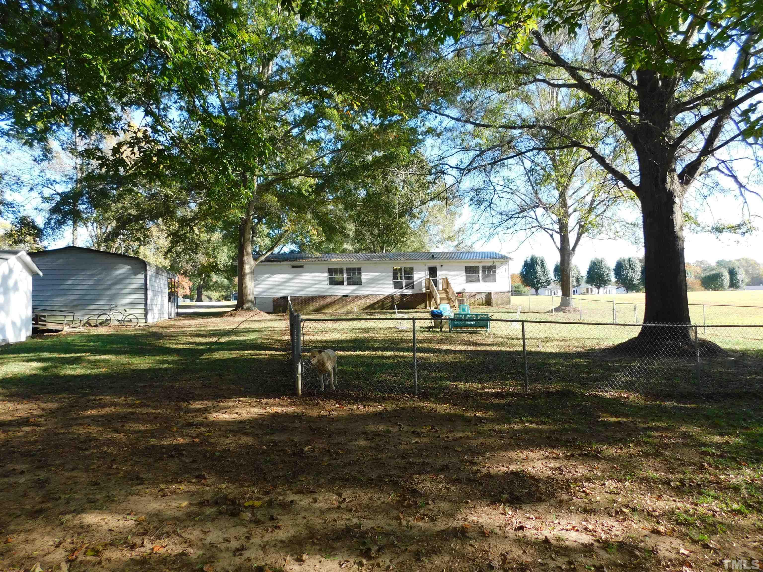 7180 Driver Road Zebulon, NC 27597 - Photo 18 of 19 a front view of a house with a garden