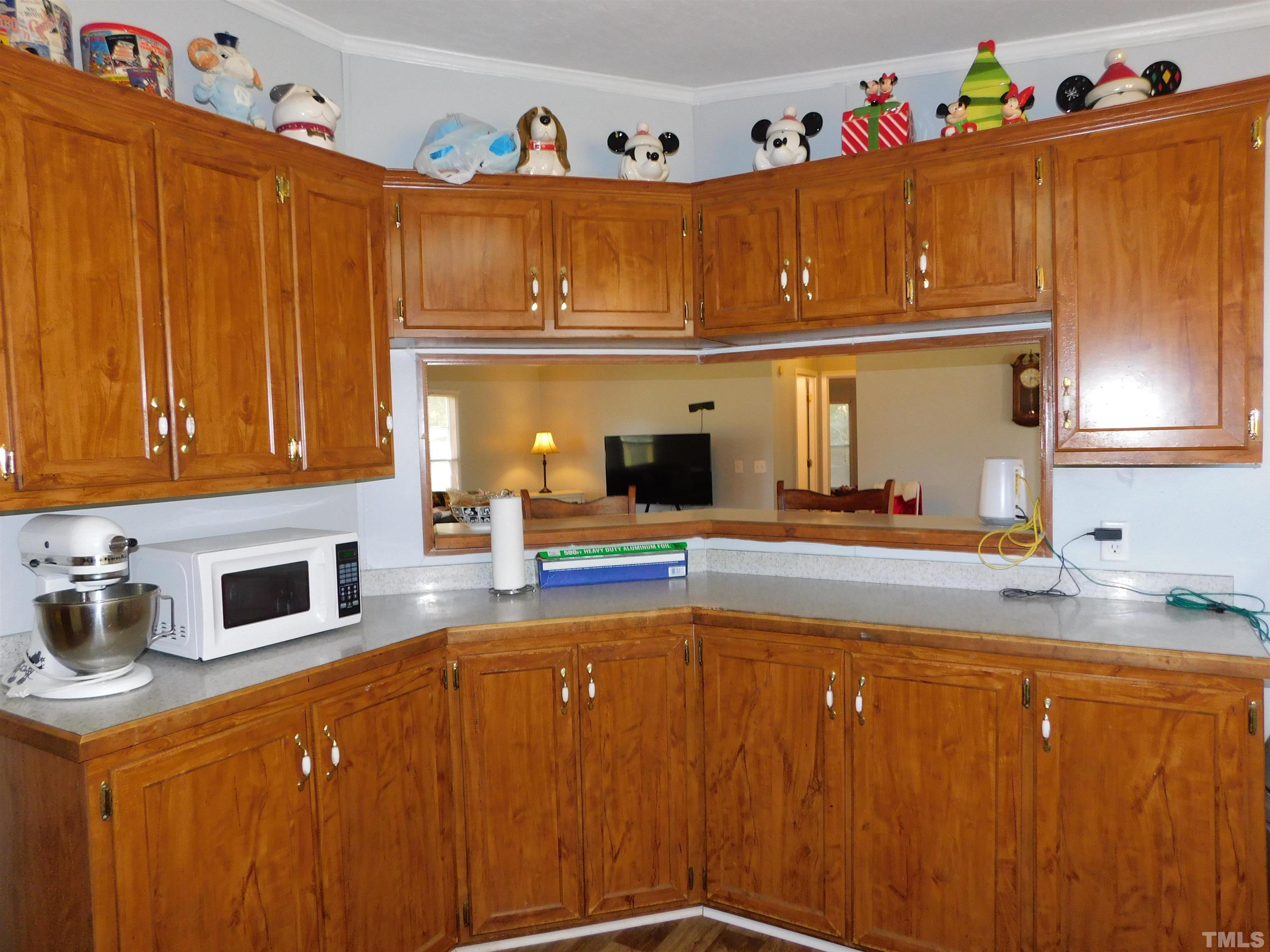 7180 Driver Road Zebulon, NC 27597 - Photo 7 of 19 a kitchen with stainless steel appliances granite countertop a refrigerator a sink dishwasher and cabinets with wooden floor