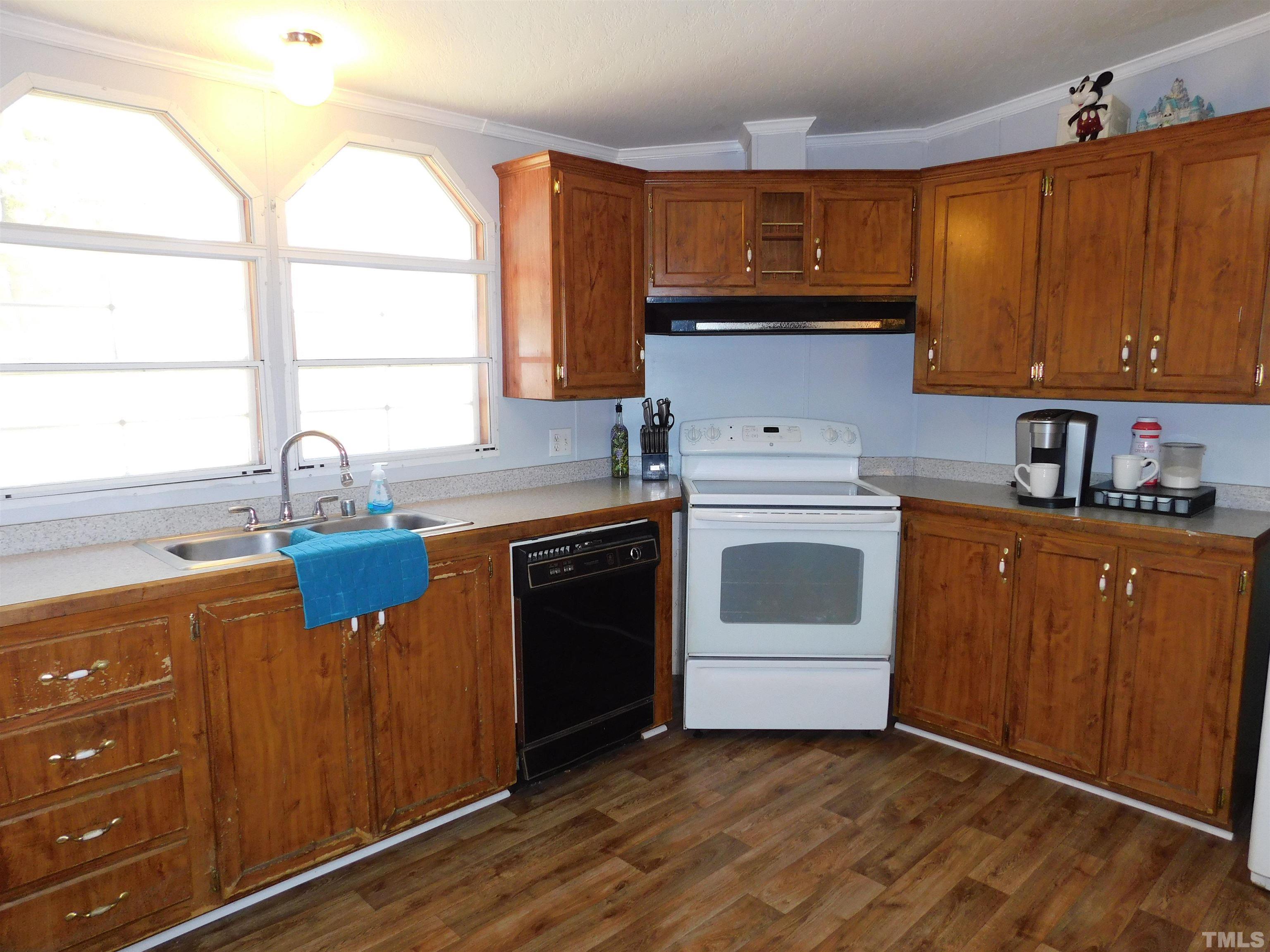 7180 Driver Road Zebulon, NC 27597 - Photo 8 of 19 a kitchen with granite countertop a sink cabinets stainless steel appliances and a window