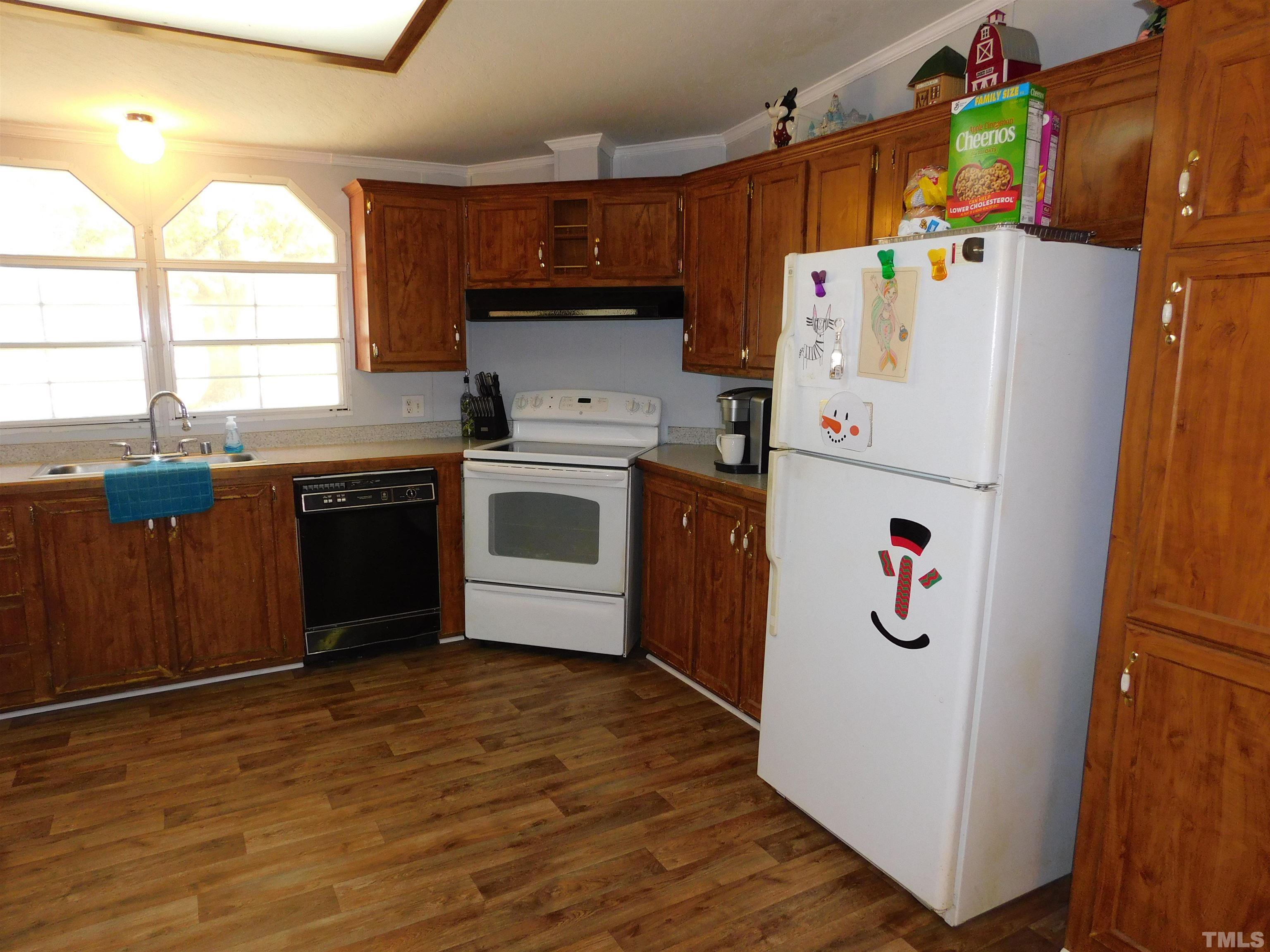 7180 Driver Road Zebulon, NC 27597 - Photo 9 of 19 a kitchen with refrigerator and window