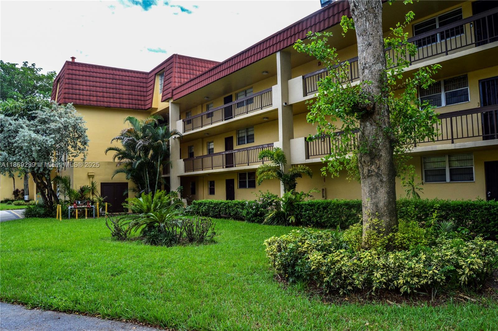 3490 Foxcroft Road, Unit B212 Miramar, FL 33025 - Photo 1 of 21 a front view of a multi story building with yard
