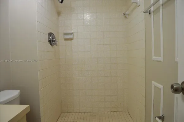 a bathroom with a toilet and shower