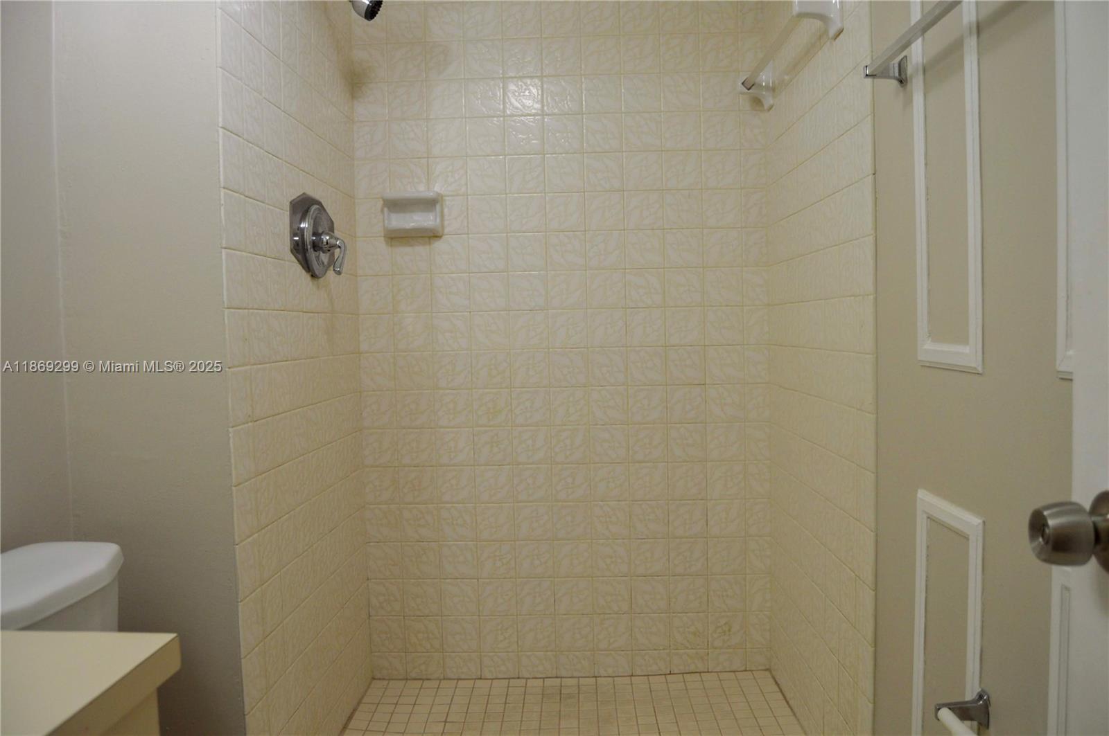 3490 Foxcroft Road, Unit B212 Miramar, FL 33025 - Photo 11 of 21 a bathroom with a toilet and shower