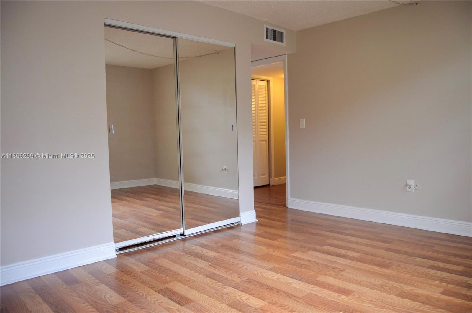 3490 Foxcroft Road, Unit B212 Miramar, FL 33025 - Photo 14 of 21 a view of an empty room with wooden floor and a bathroom