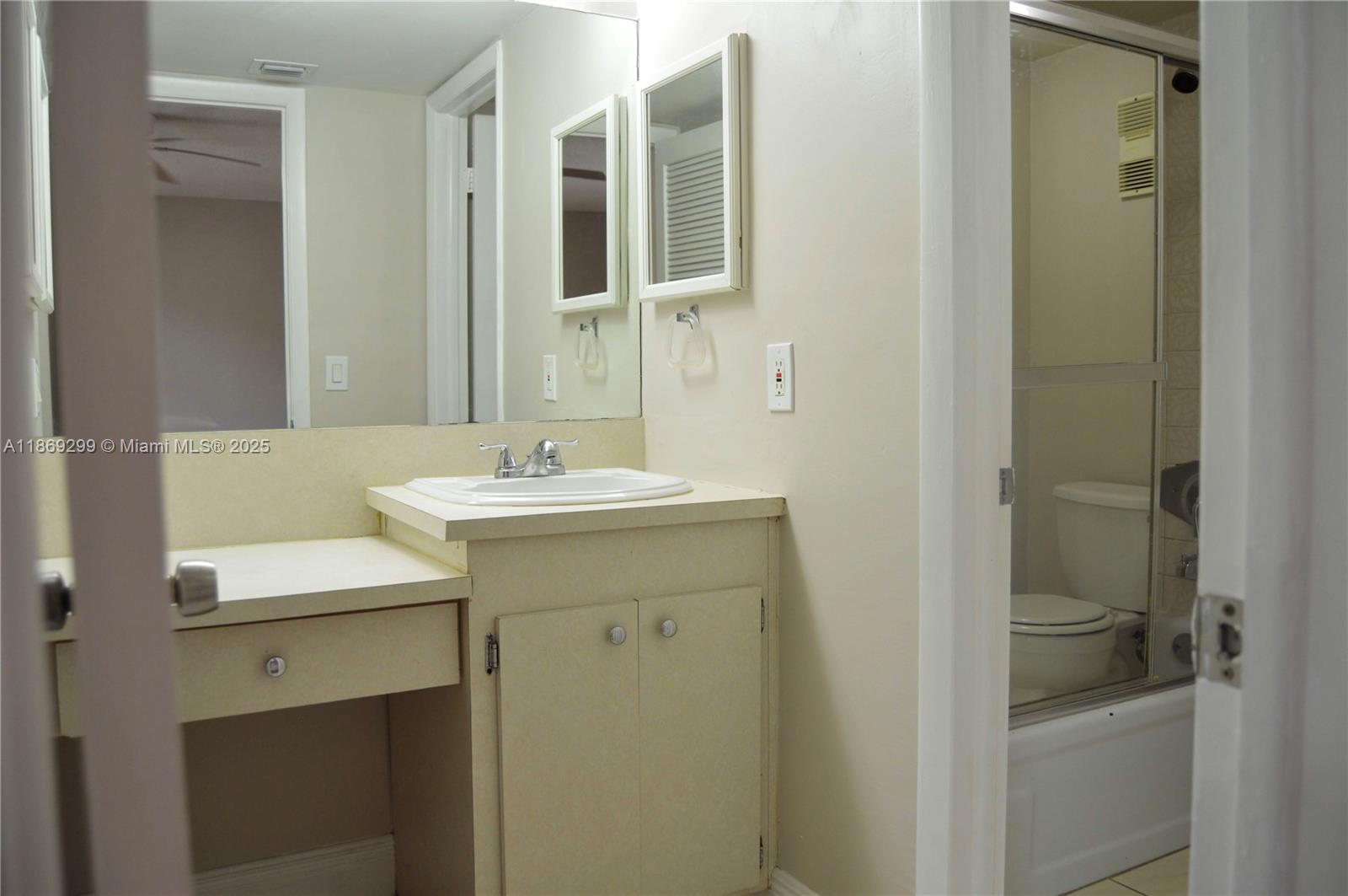 3490 Foxcroft Road, Unit B212 Miramar, FL 33025 - Photo 16 of 21 a bathroom with a sink and a mirror