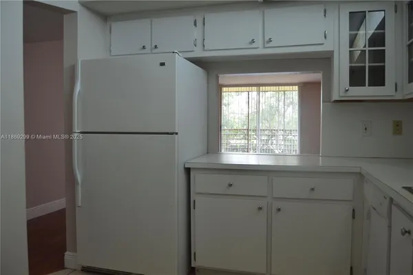 a white refrigerator freezer sitting inside of a kitchen