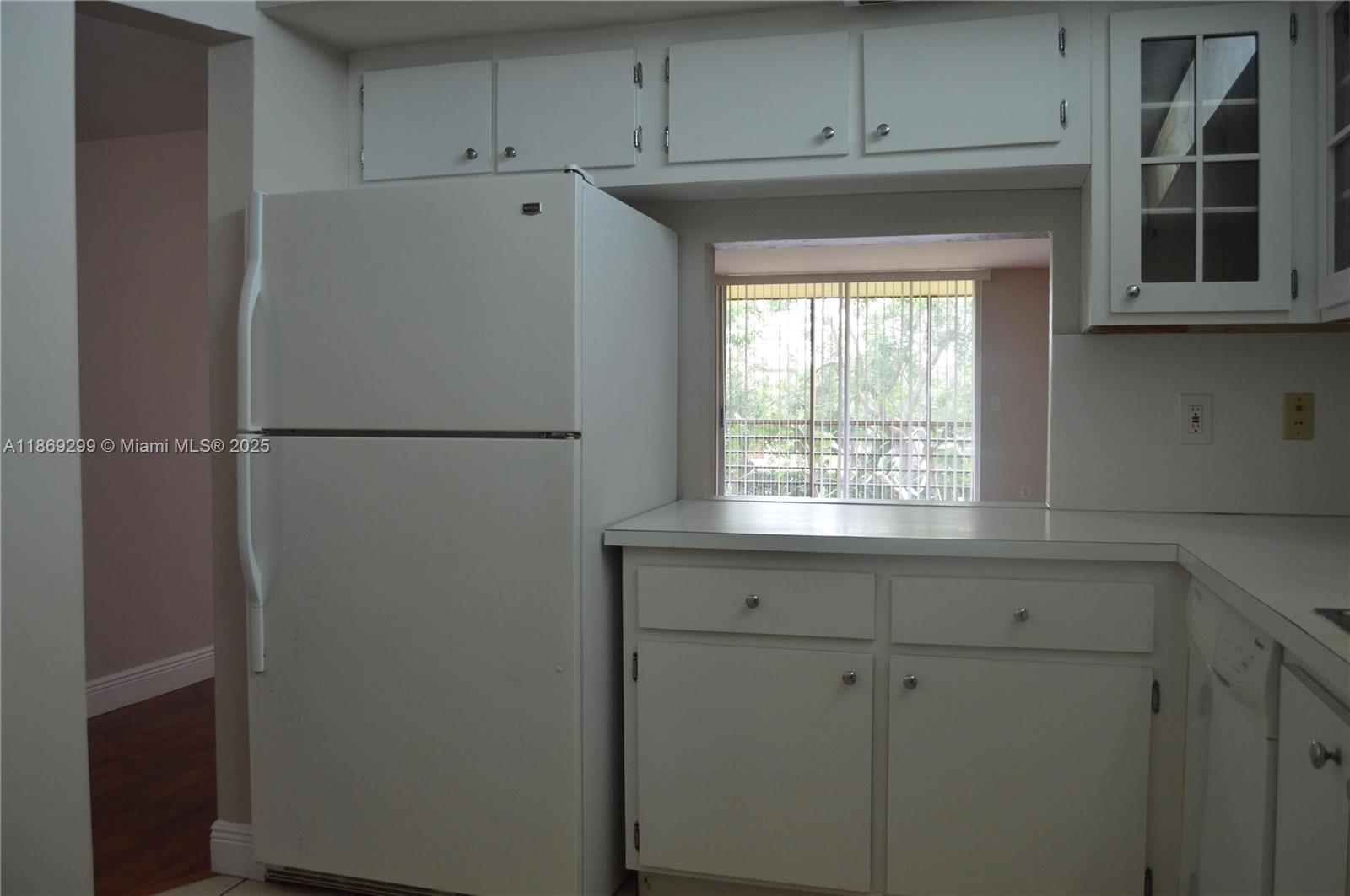 3490 Foxcroft Road, Unit B212 Miramar, FL 33025 - Photo 7 of 21 a white refrigerator freezer sitting inside of a kitchen
