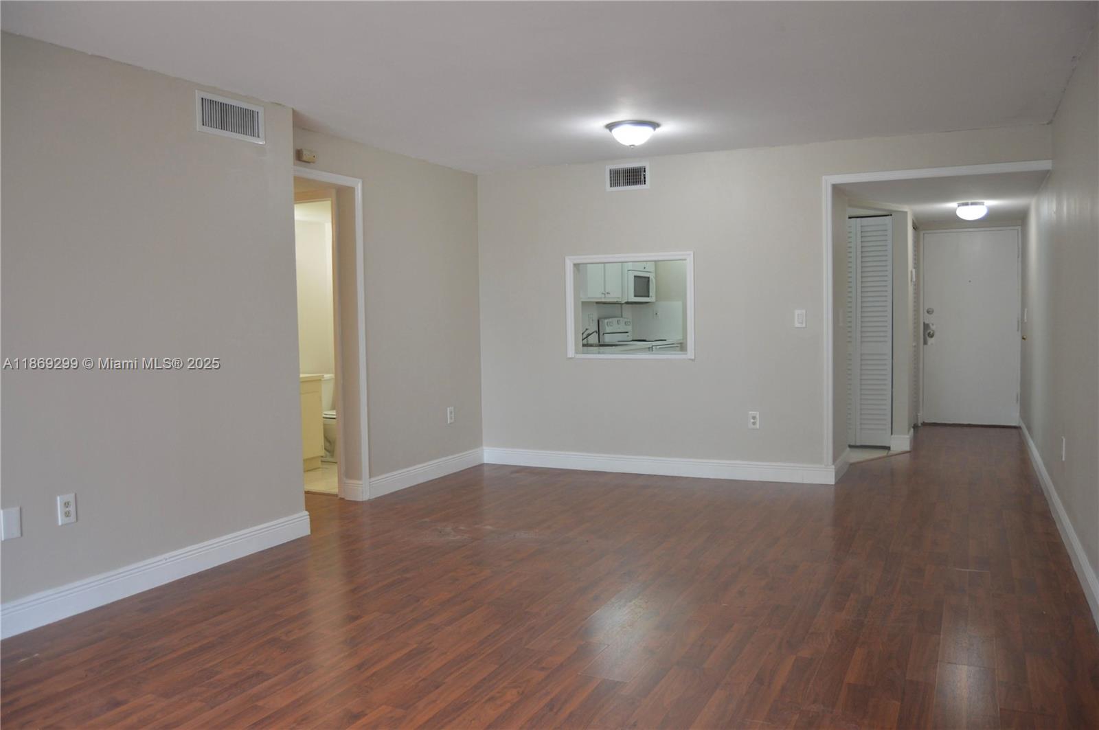 3490 Foxcroft Road, Unit B212 Miramar, FL 33025 - Photo 8 of 21 an empty room with wooden floor and windows