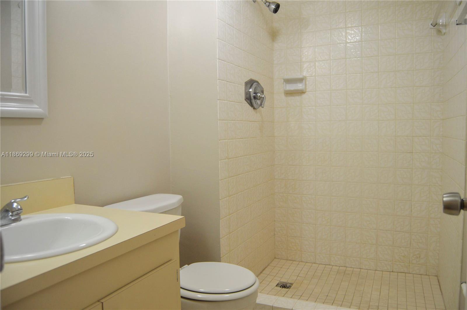 3490 Foxcroft Road, Unit B212 Miramar, FL 33025 - Photo 10 of 21 a bathroom with a sink a toilet and shower
