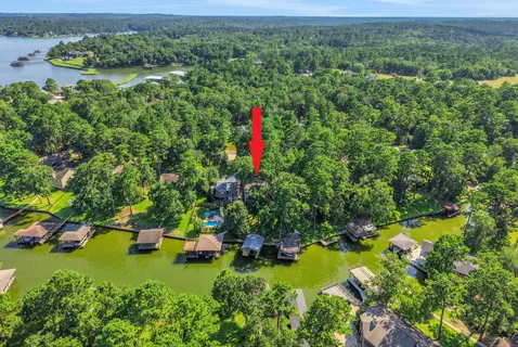 a aerial view of a house with a yard and lake view