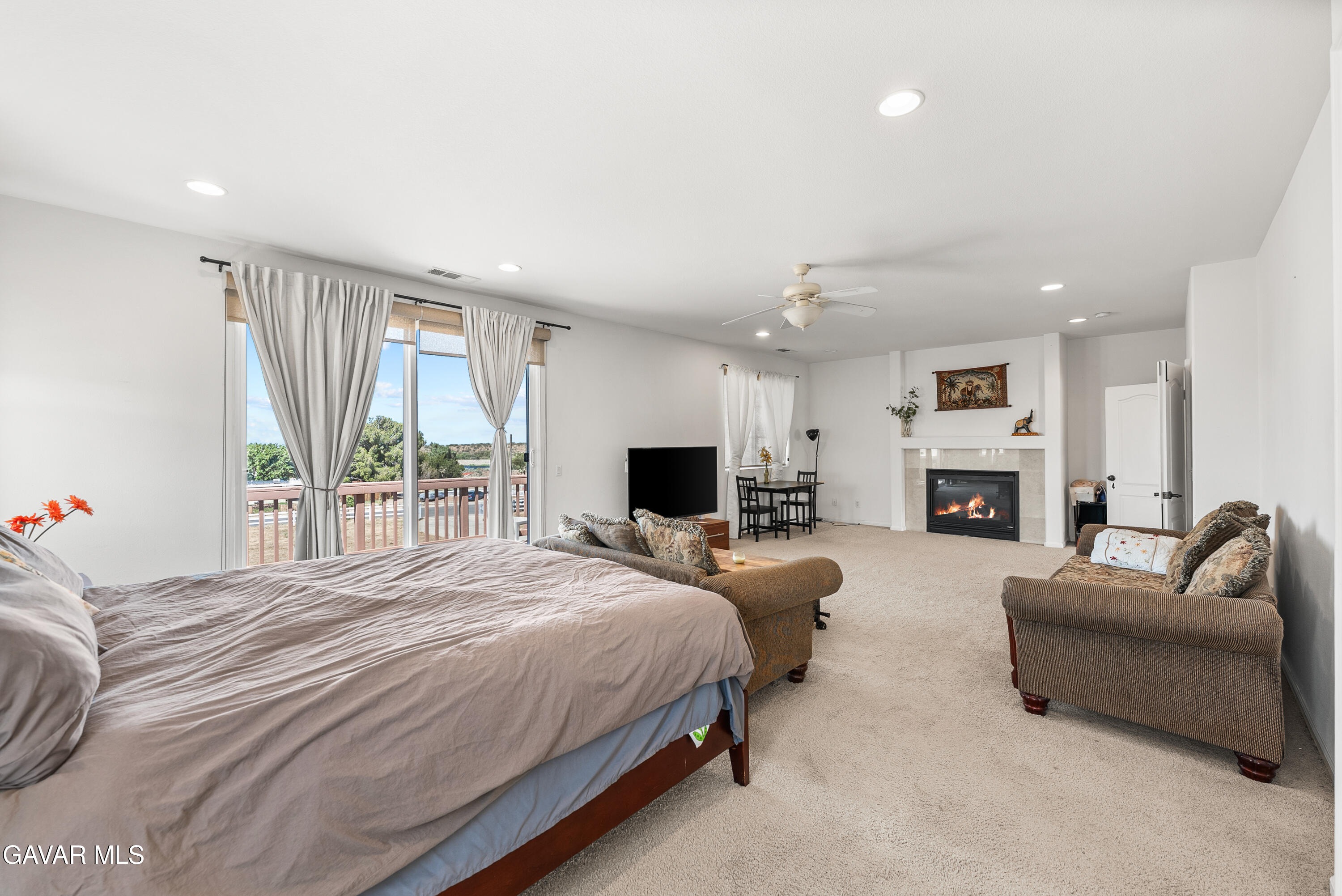 658 Lago Lindo Road Palmdale, CA 93550 - Photo 52 of 91 a spacious bedroom with a large bed and a couch