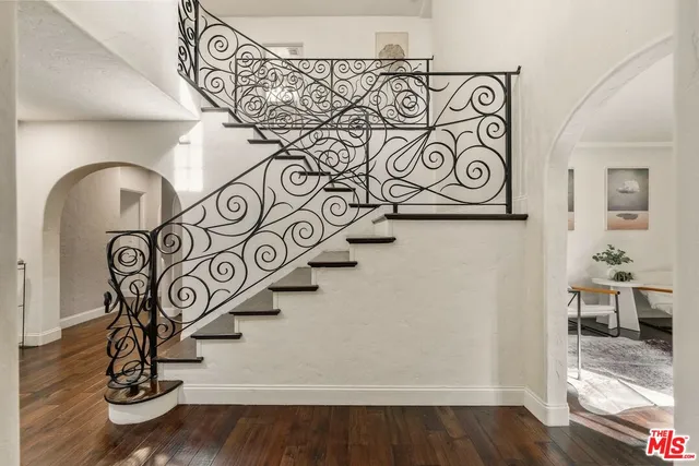 a dining room with furniture a chandelier and wooden floor