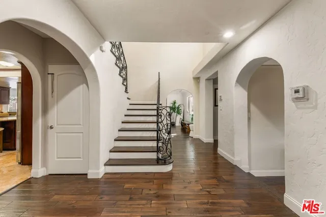 a living room with furniture rug and wooden floor