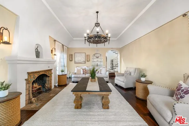 a living room with furniture a wooden floor and a window