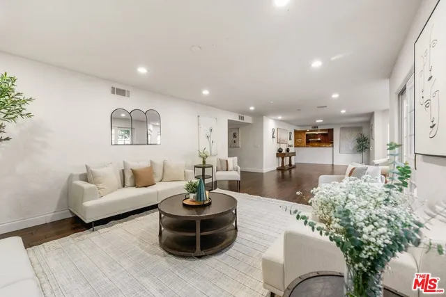 a view of a swimming pool with chairs and table in the patio